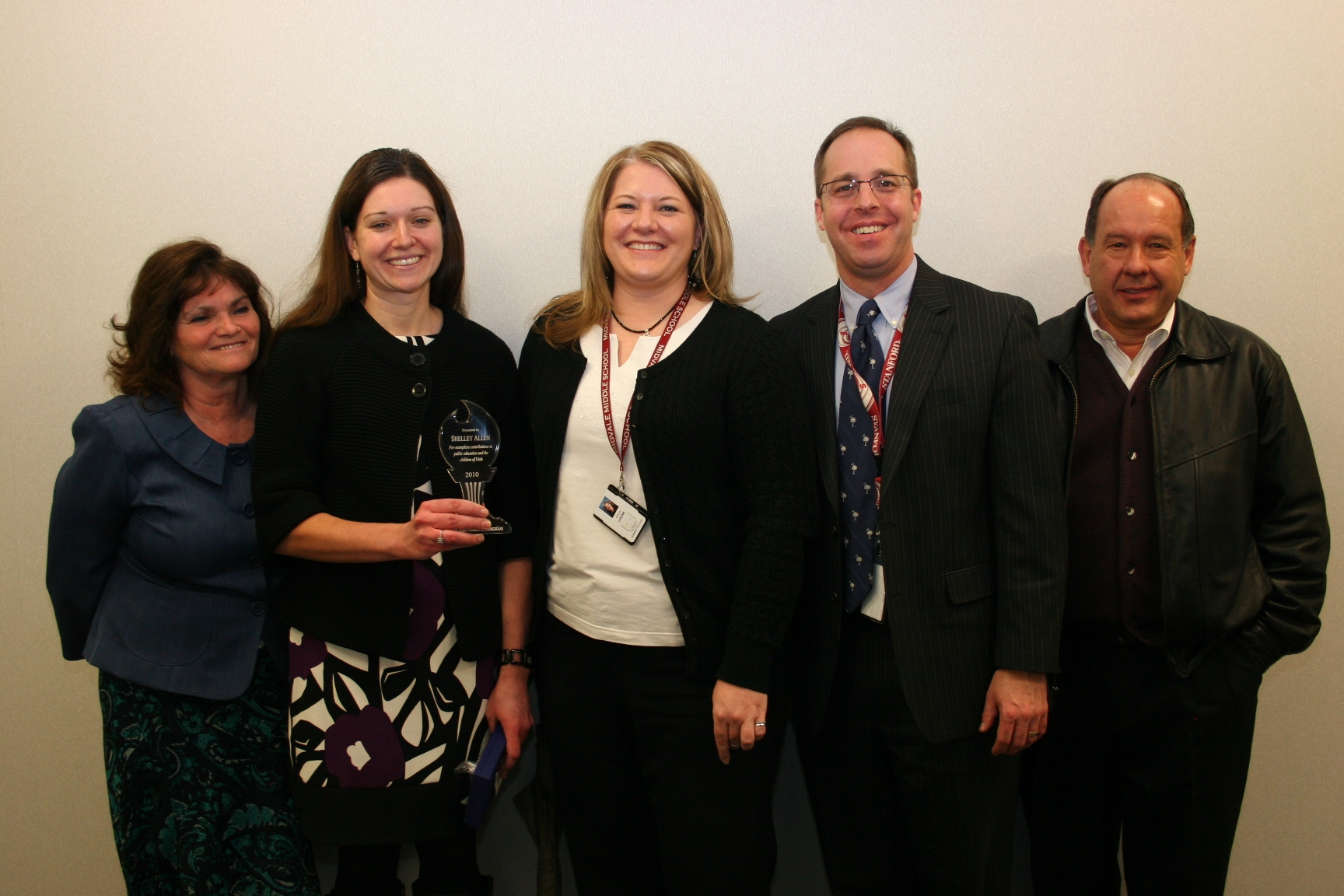 Shelley Allen, second from right, shows her award. She is pictured with her mother, xx, Midvale Middle Principal Paula Logan, Canyons Superintendent David Doty, and Canyons Board of Education Member Mont Millerberg.